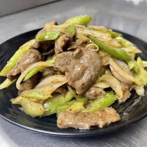onion, celery in brown sauce with ground black pepper