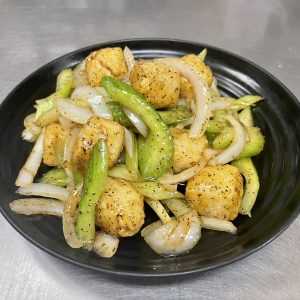 fried tofu, celery, and onion in a garlic brown sauce with ground black pepper