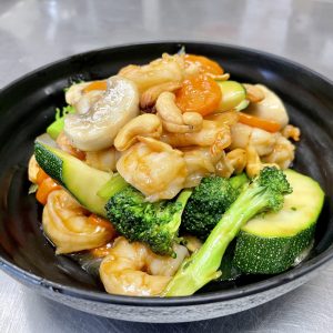 broccoli, zucchini, onion, carrots, celery topped with cashews