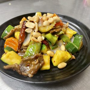 bell peppers, onion, carrot, celery, in a spicy sauce topped with peanuts