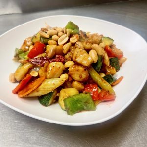 Zucchini, bell peppers, onion, carrot, celery, in a spicy sauce topped with peanuts