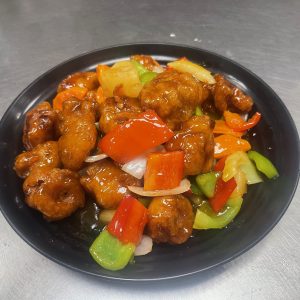 Breaded pork with pineapple, onion, bell peppers, carrot, celery